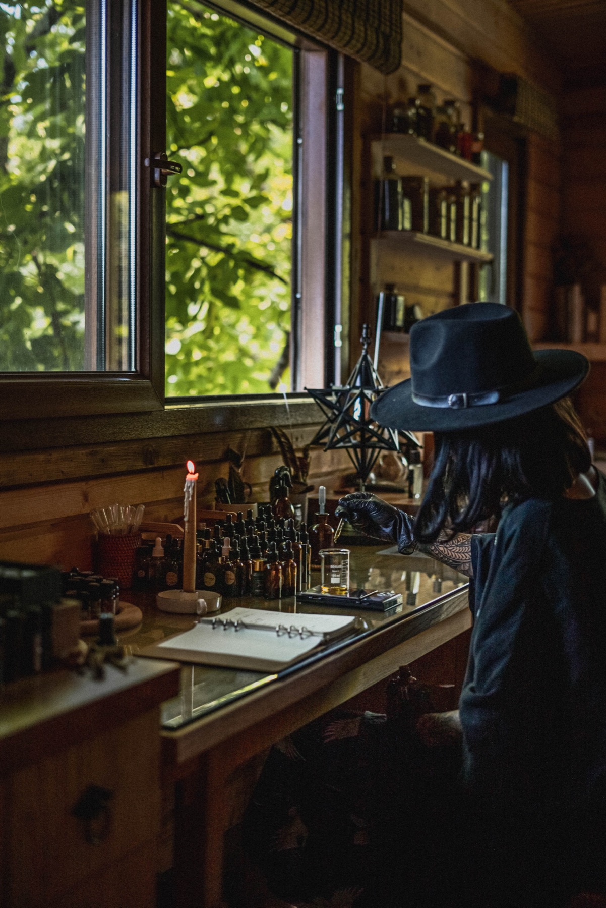 The perfumer at work in an off-grid cabin laboratory in the northern rainforest of Iran